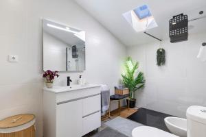 a white bathroom with a sink and a mirror at Cantinho D'Amy in Arcos de Valdevez +12 photos