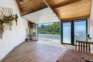 a living room with wooden ceilings and a large window at Cantinho D'Amy in Arcos de Valdevez