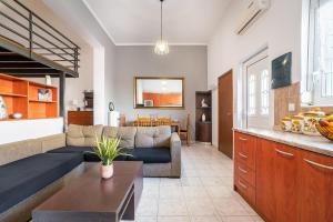 a living room with a couch and a table at Rafaela's House in Koskinou