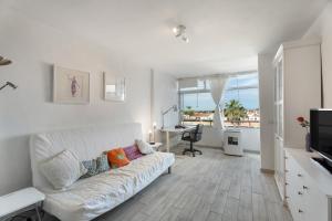 a living room with a white couch and a desk at Casa Candido in Arona
