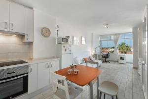 a kitchen and living room with a table and a dining room at Casa Candido in Arona