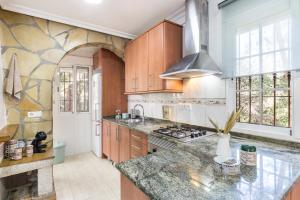 a kitchen with wooden cabinets and a granite counter top at Mi Bella in Totana