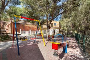 a playground with colorful swings in a park at Mi Bella in Totana