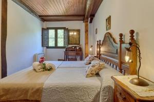 a bedroom with a large bed and a desk at El Pajariel I in Valdecañada
