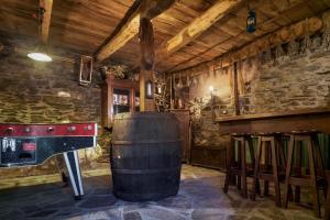 a wine tasting room with a barrel and a table at El Pajariel I in Valdecañada