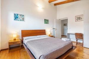 a bedroom with a bed and a table and a chair at Tanas in Tenno