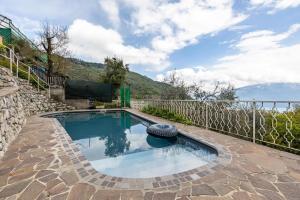 a swimming pool with a tire in the middle at Tanas in Tenno
