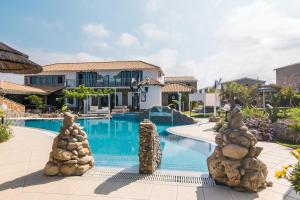 a villa with a swimming pool and a resort at Mirage Arillas Studio Type A4 in Arillas