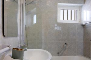 a bathroom with a shower and a tub and a sink at Casa Vasconcelos in Afife +7 photos