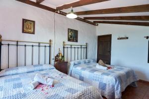 a bedroom with two beds in a room at La Sierrezuela in Castillo de Locubín +33 photos