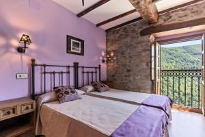 a bedroom with a bed and a large window at Lago Gabriel - Villar de Posada in Caldevilla de Rengos