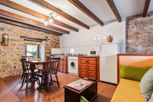 a kitchen and dining room with a table and chairs at Lorences D in Caunedo +15 photos