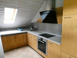 a kitchen with a sink and a stove top oven at Ferienwohnung Geistalblick in Neuenstein