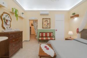 a bedroom with a bed and a sink and a mirror at Pomona Noto in Noto