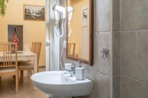 a bathroom with a sink and a mirror at Pomona Noto in Noto +12 photos