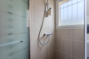 a shower with a shower head in a bathroom at Gite Gousseau in Buzy