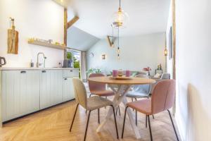 a kitchen and dining room with a table and chairs at Ferrienhaus Land Hof Spelle in Spelle +18 photos