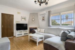 a living room with a couch and a tv at Casa Alfonso Manuel in Roche