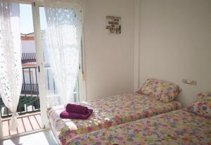 a living room with a couch and a window at Casa Danca Cabopino in Marbella