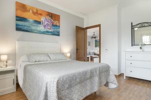 a white bedroom with a bed and a mirror at Casa Alfonso Manuel in Roche +22 photos