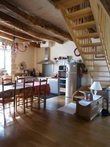 a kitchen and dining room with a table and chairs at Maison Typique Au Calme in Coubisou
