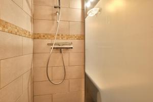 a shower with a shower head in a bathroom at Appartement Le Serpaton in Gresse-en-Vercors +14 photos