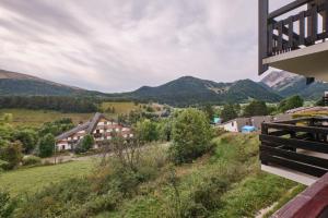 a view of the mountains from a house at Appartement Le Serpaton in Gresse-en-Vercors