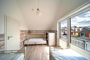 a room with two beds and a large window at Boje by Seeblick ferien oro in Kappeln