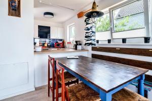 a kitchen with a wooden table and chairs at Boje by Seeblick ferien oro in Kappeln