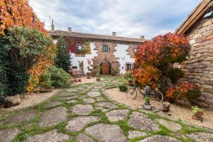 a stone pathway in front of a house with a building at La Casona De Barrio in Barrio