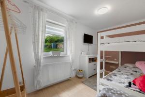 a bedroom with a bunk bed and a window at Bella Casa in Sankt Wendel