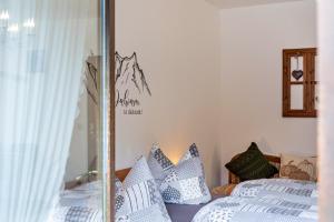 a bedroom with two beds and a glass wall at Aschaubichl - Wohnung Silberdistel in Grainau