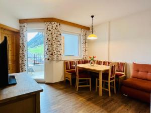 a living room with a table and a couch at Alpenflora 2 in Ischgl