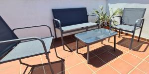two chairs and a table on a balcony at La Cala Apartment in La Cala de Mijas
