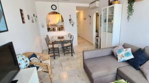 a living room with a couch and a table at La Cala Apartment in La Cala de Mijas