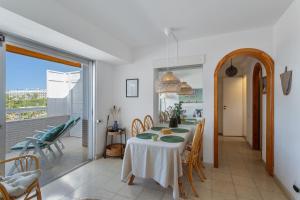 a dining room with a table and a balcony at Al Mar en San Agustín in San Bartolomé