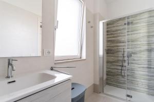 a bathroom with a sink and a glass shower at Suite Buena Vista in Gallipoli +19 photos