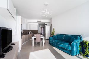 a living room with a blue couch and a table at Suite Buena Vista in Gallipoli