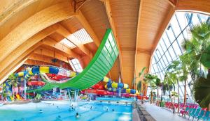 a large indoor swimming pool with a water slide at Haus Scherer in Sankt Peter