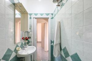 a bathroom with a sink and a mirror at White Sand Private Villa in Torre Squillace