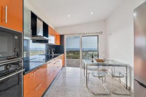 a kitchen with a glass table and a view at Casa Miramar in Frontera
