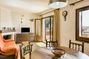 a living room with a table and a television at Casa Saguer in L'Escala