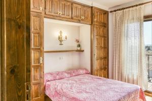 a bedroom with a bed and a large wooden cabinet at Casa Saguer in L'Escala +25 photos