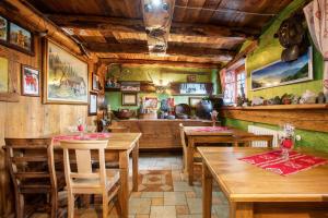 a restaurant with wooden tables and chairs in a room at Affittacamere Saint-Salod in Charvensod
