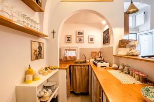 a kitchen with a counter and an archway above it at Casa Agata Cisternino in Cisternino +17 photos