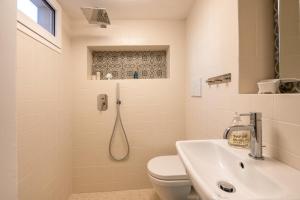 a bathroom with a toilet and a sink at Casa Agata Cisternino in Cisternino