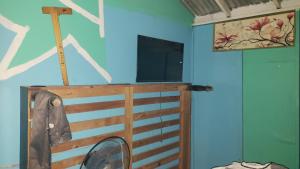 a room with a bed and a tv on a wall at rushels in Drunkenmans Cay