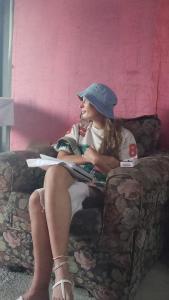 a woman sitting on a couch reading a book at rushels in Drunkenmans Cay