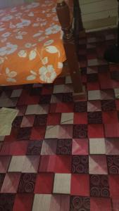 a checkerboard floor with a bed in a room at rushels in Drunkenmans Cay