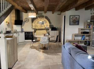 a living room with a couch and a table at Gîte Rosa Bonheur in Saint-Cernin